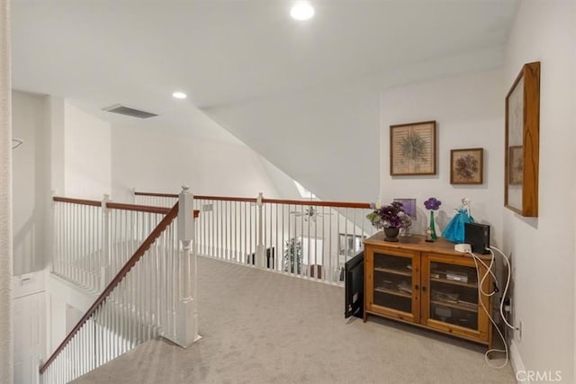 hallway featuring carpet floors, lofted ceiling, visible vents, and recessed lighting