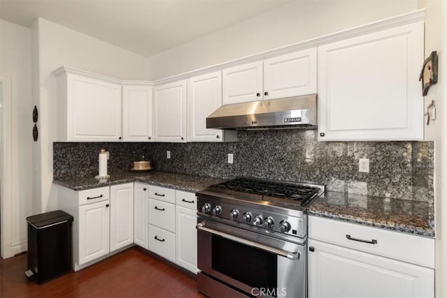 kitchen featuring under cabinet range hood, dark wood-style flooring, white cabinets, high end stainless steel range oven, and backsplash