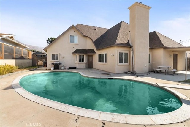 view of pool with area for grilling, a patio area, and a fenced in pool