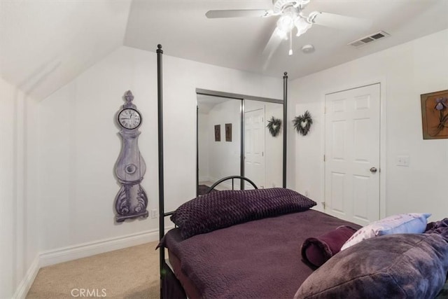 bedroom with a closet, visible vents, carpet flooring, vaulted ceiling, and baseboards