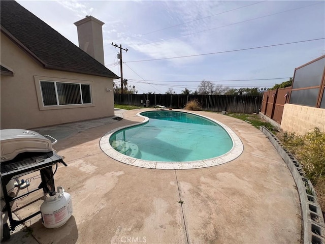 view of swimming pool featuring a patio, area for grilling, a fenced backyard, and a fenced in pool