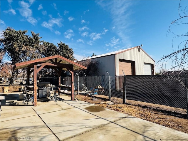 view of patio with a gazebo, a garage, and an outdoor structure