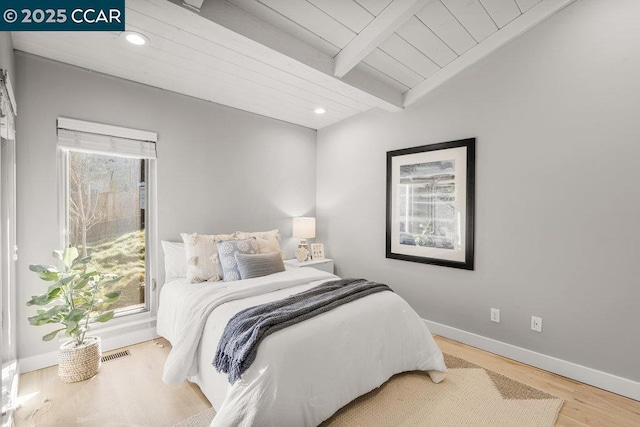 bedroom with hardwood / wood-style flooring, wood ceiling, and lofted ceiling with beams