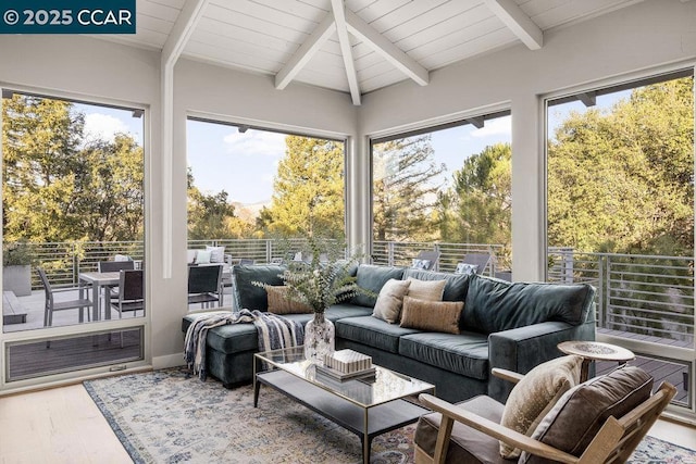 sunroom featuring wood ceiling, lofted ceiling with beams, and a healthy amount of sunlight