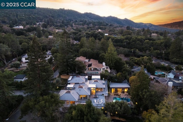 aerial view at dusk featuring a mountain view