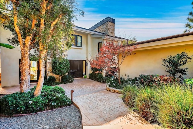 property entrance featuring a patio