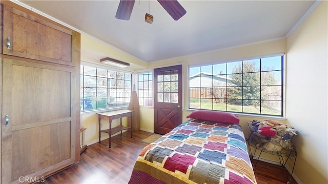 bedroom featuring ceiling fan, baseboards, and wood finished floors