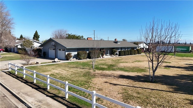 single story home with driveway, a front lawn, and fence