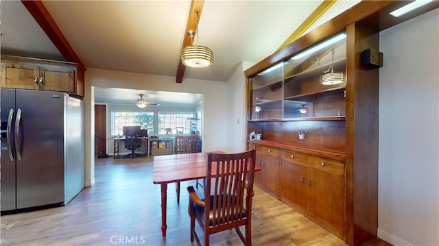 dining area featuring beam ceiling, baseboards, light wood-type flooring, and ceiling fan