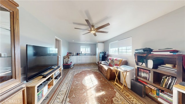 living area featuring wood finished floors and a ceiling fan