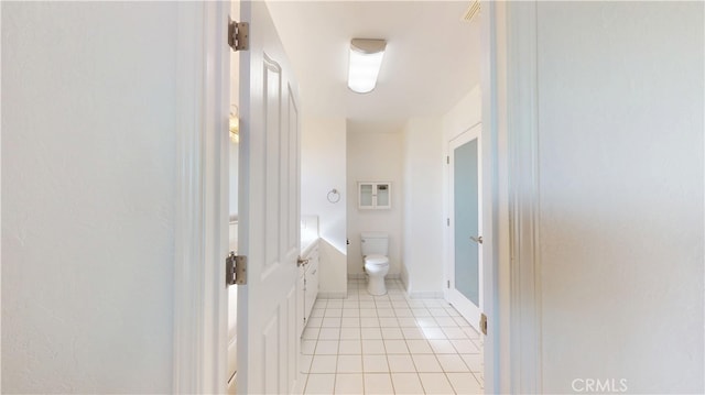 bathroom with toilet and tile patterned flooring