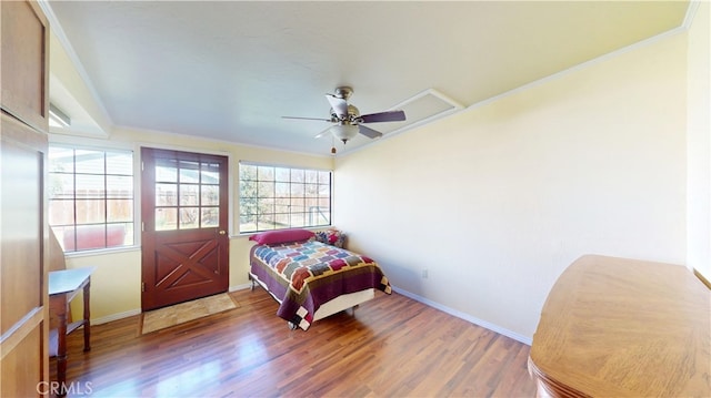 bedroom featuring wood finished floors, baseboards, and ceiling fan