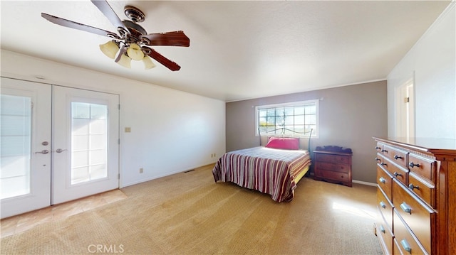 bedroom with light carpet, visible vents, french doors, and a ceiling fan