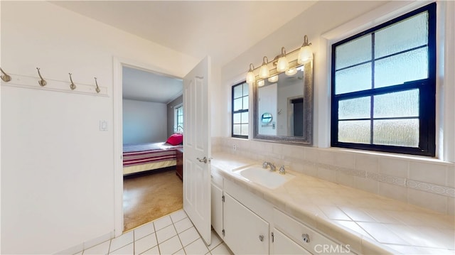 bathroom with tile patterned flooring, backsplash, and vanity