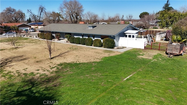 exterior space featuring a front lawn and fence