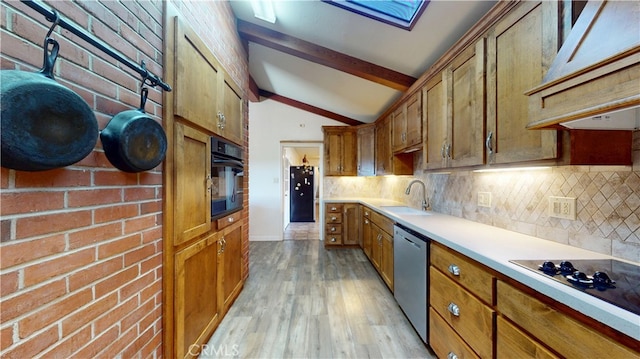 kitchen featuring brown cabinetry, vaulted ceiling with beams, a sink, black appliances, and tasteful backsplash