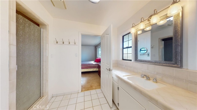 bathroom featuring vanity, decorative backsplash, an enclosed shower, tile patterned floors, and connected bathroom