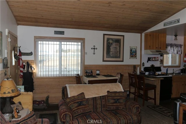 living room with wood ceiling, lofted ceiling, and wood walls