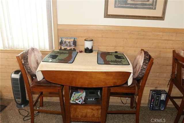 dining space featuring wooden walls