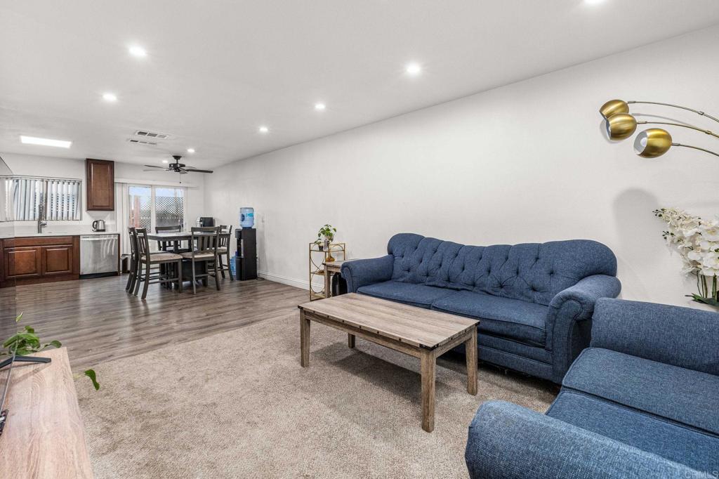 living room with hardwood / wood-style flooring, sink, and ceiling fan