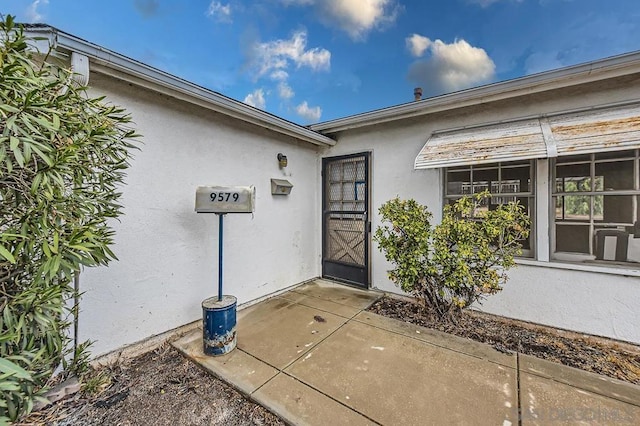 entrance to property with a patio