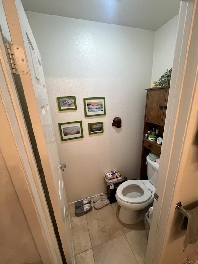 bathroom featuring tile patterned flooring and toilet