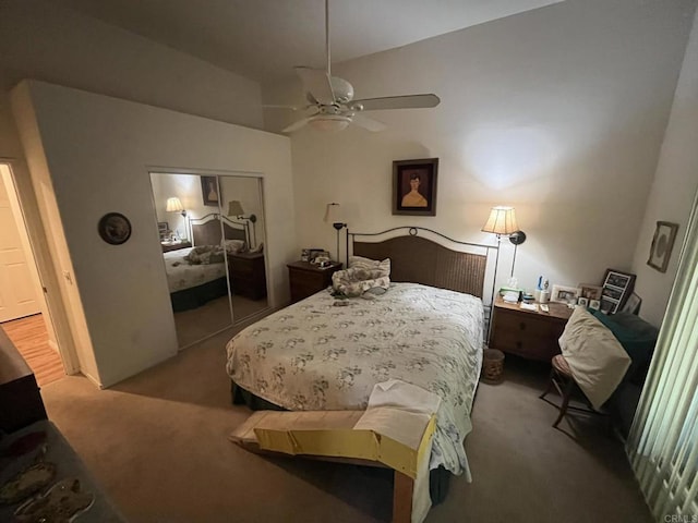 carpeted bedroom featuring vaulted ceiling, ceiling fan, and a closet