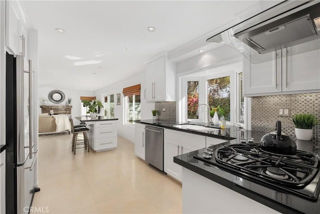 kitchen with white cabinetry, sink, stainless steel appliances, and exhaust hood