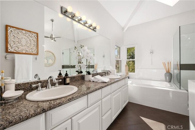 bathroom with independent shower and bath, vanity, lofted ceiling, and tile patterned floors