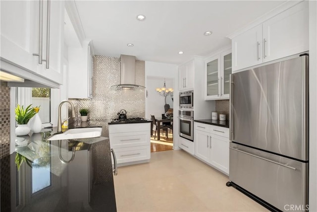 kitchen featuring sink, stainless steel appliances, white cabinets, and wall chimney exhaust hood