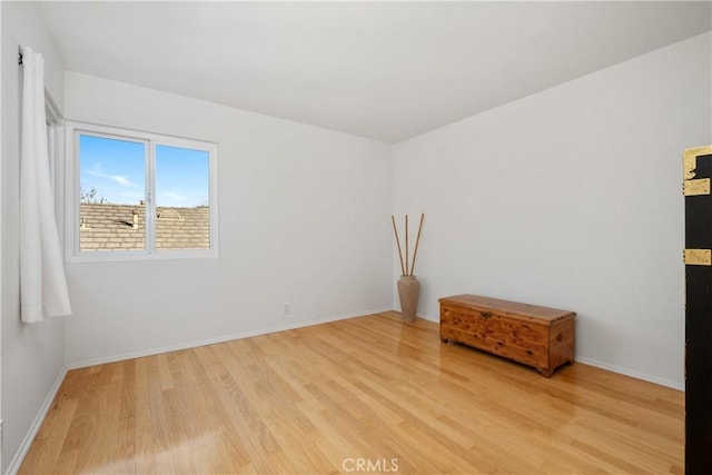 interior space featuring baseboards and light wood-style floors