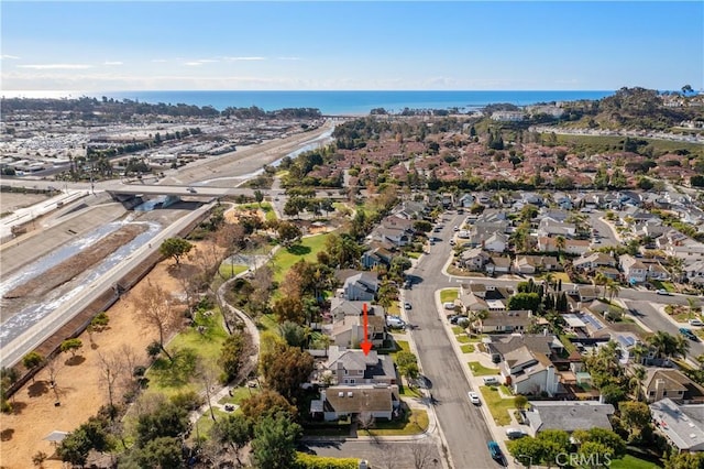 drone / aerial view with a residential view and a water view