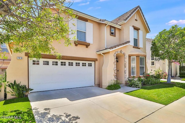 view of front of property with a garage and a front yard