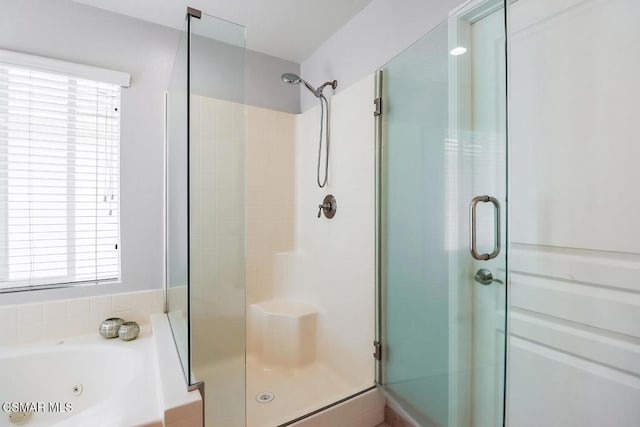 bathroom with separate shower and tub