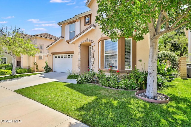 mediterranean / spanish-style house featuring a garage and a front yard