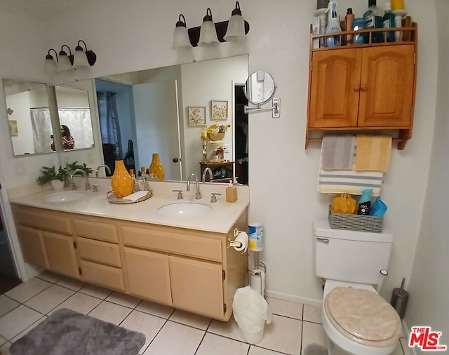 bathroom featuring vanity, toilet, and tile patterned flooring