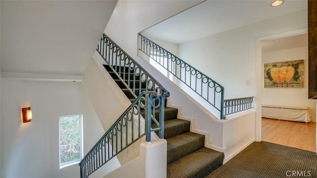 stairs featuring hardwood / wood-style floors