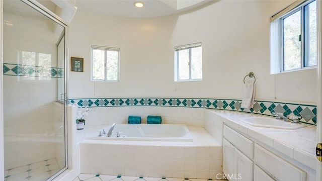 bathroom featuring independent shower and bath and vanity