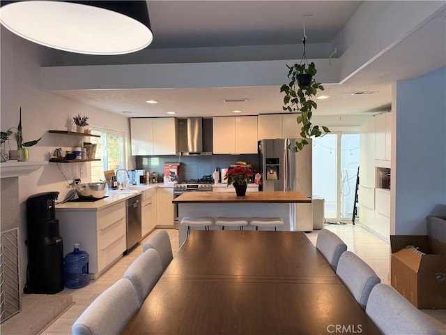 dining space with sink and light wood-type flooring