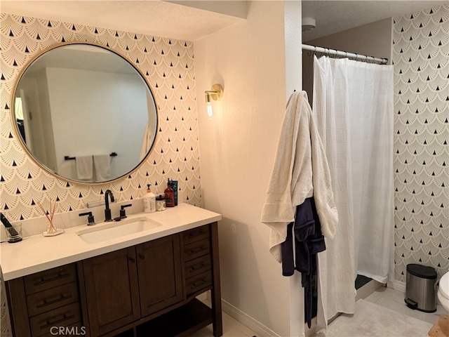 bathroom featuring vanity and curtained shower