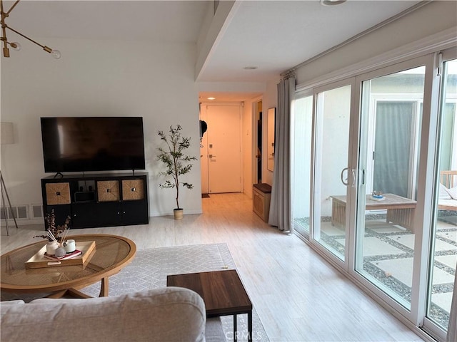 living room with hardwood / wood-style floors and a healthy amount of sunlight