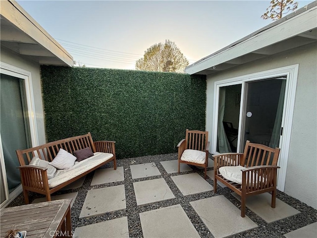 view of patio terrace at dusk