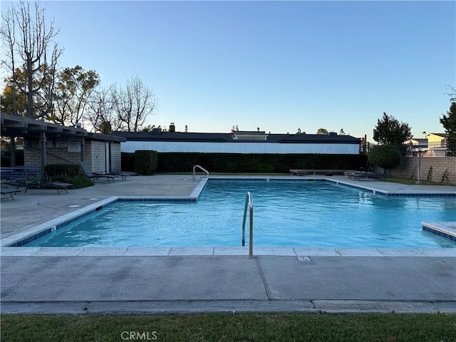 community pool featuring a patio and fence