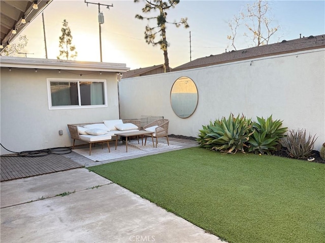 yard at dusk with a patio and an outdoor hangout area