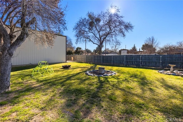 view of yard with a fire pit