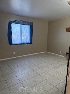 unfurnished room with light tile patterned floors