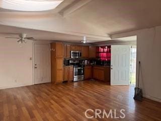 kitchen featuring hardwood / wood-style floors, stainless steel appliances, and ceiling fan