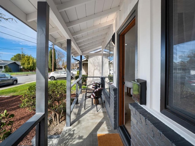 exterior space with wood ceiling and lofted ceiling with beams