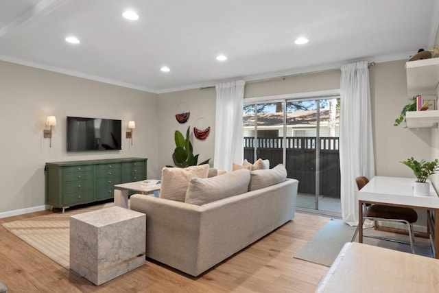 living room with ornamental molding and light hardwood / wood-style flooring