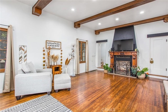 living room with hardwood / wood-style flooring and beam ceiling